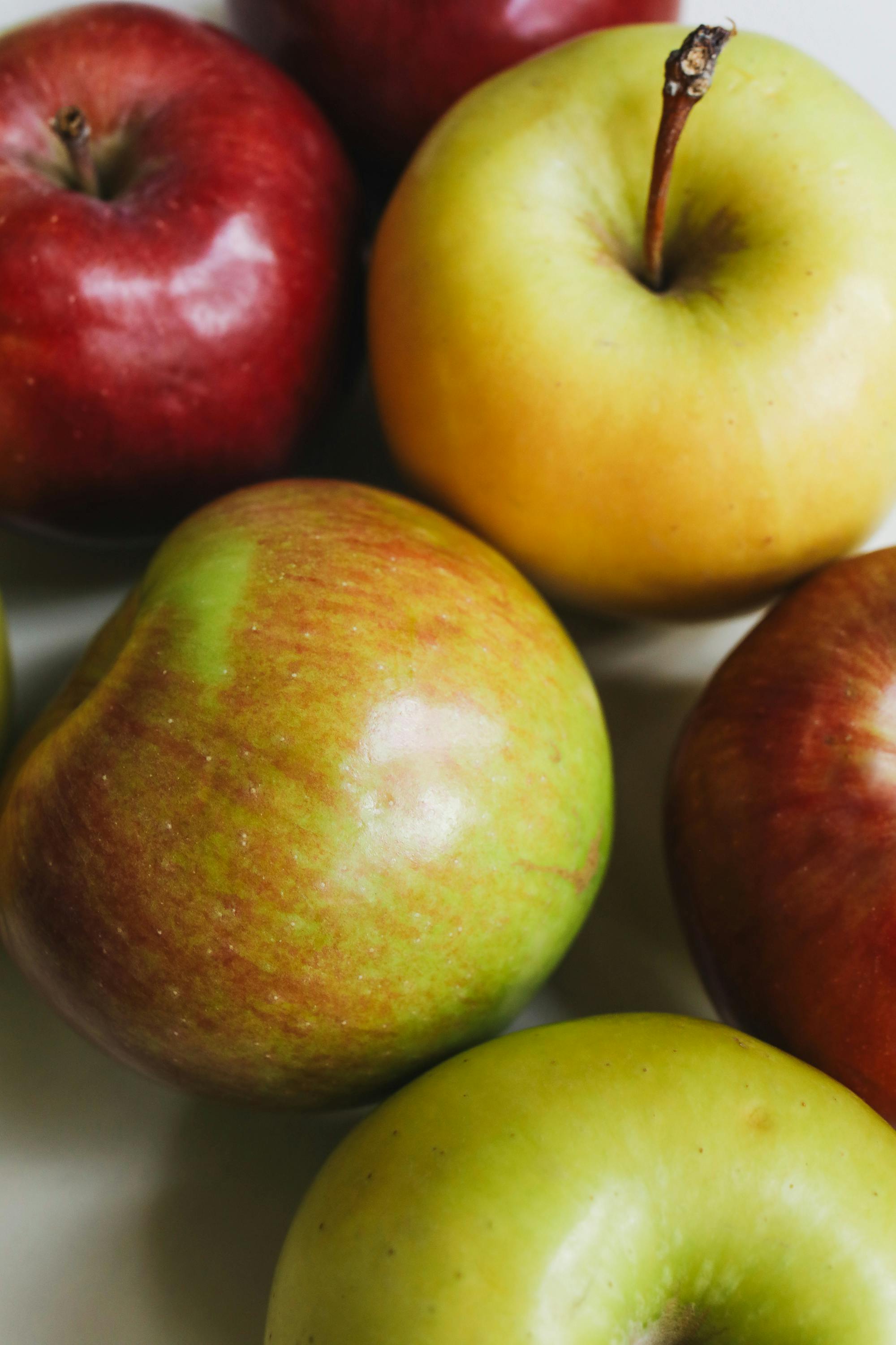 Apples in grayscale with a red apple